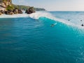 August  8, 2021. Bali, Indonesia. Aerial view with surfing on big wave. Blue perfect waves and surfers in ocean at Padang Padang Royalty Free Stock Photo