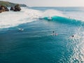 August  8, 2021. Bali, Indonesia. Aerial view with surfing on big wave. Blue perfect waves and surfers in ocean at Padang Padang Royalty Free Stock Photo