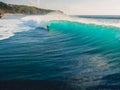 August  8, 2021. Bali, Indonesia. Aerial view with surfing on big wave. Blue perfect waves and surfers in ocean at Padang Padang Royalty Free Stock Photo