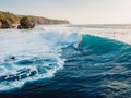 August  8, 2021. Bali, Indonesia. Aerial view with surfing on big wave. Blue perfect waves and surfers in ocean at Padang Padang Royalty Free Stock Photo