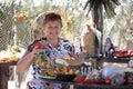 Elderly Russian woman with preserves and food.