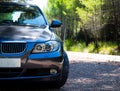 BMW 3 series E90 330i Sparkling Graphite at the mountain road Royalty Free Stock Photo