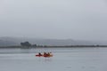 Dramatic image of tourist kayaking on the California coast enjoying the calm waters of Bodega Bay, California. Royalty Free Stock Photo