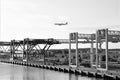 Jet Blue flight flies overhead container terminal in Boston Harbor