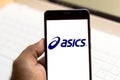 August 2, 2019, Brazil. In this photo illustration the ASICS logo is displayed on a smartphone Royalty Free Stock Photo