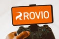 August 9, 2023, Brazil. A person playing on a joystick and the Rovio Entertainment Corporation logo Royalty Free Stock Photo