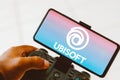 August 9, 2023, Brazil. A person playing on a joystick and the Ubisoft Entertainment logo displayed on Royalty Free Stock Photo