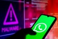 August 25, 2021, Brazil. In this photo illustration the WhatsApp logo displayed on a smartphone with malware alert in the