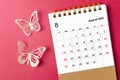 A August 2023 calendar desk for the organizer to plan and reminder with butterfly paer on red background Royalty Free Stock Photo