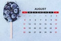 August calendar. Stack of frozen sweet cherries with August month calendar. Summer Royalty Free Stock Photo