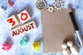 August 30 - Daily colorful Calendar with Block Notes and Pencil on wood table background