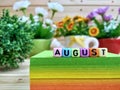August. Colorful cube letters on sticky note block.