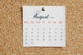 August 2021. Concept of full calendar page for month. White calendar sheet attached to brown cork board with days, weeks