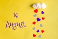 16 august day of month, colorful hearts rain from a white cotton cloud on a yellow background. Valentine's day, love and