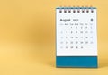 The August 2023 desk calendar on yellow color background