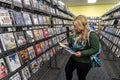 AUGUST 12 2018 - FAIRBANKS, AK: Blonde woman shops for movie rentals in a Blockbuster Video store Royalty Free Stock Photo