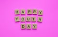 International Youth Day, minimalistic banner with the inscription in wooden letters Happy Youth Day Royalty Free Stock Photo