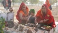 Indian women offer milk or sacred food by hand to the idol of the god. Hinduism and festival concept