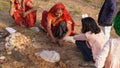 Indian women offer milk or sacred food by hand to the idol of the god. Hinduism and festival concept