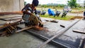 August 2018,Kolkata, India, A male worker cutting steel bar with motorized Bosch Steel Rod Cutter and generating sparks