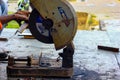 August 2018,Kolkata, India, A male worker cutting steel bar with motorized Bosch Steel Rod Cutter and generating sparks