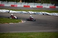 Two kart racers in a corner fighting each other for position in a race