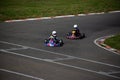 Two kart racers in a corner fighting each other for position