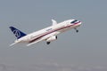 30 AUGUST 2019 MOSCOW, RUSSIA: A passenger plane flying in the overcast sky - SUKHOI SUPERJET100 Royalty Free Stock Photo