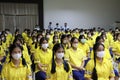 August 1, 2023, Nakhon Sawan, Thailand. Young student girls wearing face masks sit in the conference room in the morning.