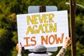 August 5, 2019 Palo Alto / CA / USA - Protester holding a sign with the message `Never again is now` at the rally against the curr Royalty Free Stock Photo