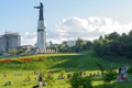 People walk with their families on the lawn around the monument to Mother Patroness. Cheboksary. Russia Royalty Free Stock Photo