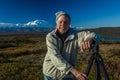 AUGUST 28, 2016 - Photographer Joe Sohm poses at famous Ansel Adams picture spot, Wonder Lake, Mount Denali, Kantishna, Alaska