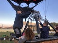 People and team getting ready to inflate and fly hot air balloon.