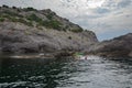 August 27, 2021 Republic of Crimea, suburbs of the city of Novy Svet, editorial. People swim in a small rocky bay