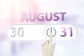 August 31st . Day 31 of month, Calendar date.Hand finger switches pointing calendar date on sunlight office background. Summer