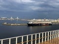 Cruise ship approaching dock. St. Petersburg, Russia. Skyline of city, Krestovsky Stadium, and bridge seen from ship Royalty Free Stock Photo