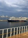 Cruise ship approaching dock. St. Petersburg, Russia. Skyline of city, Krestovsky Stadium, and bridge seen from ship Royalty Free Stock Photo