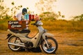 August 08, 2023. Surabaya, Indonesia. Barista on bike selling drinks during sunset in a hill forest.