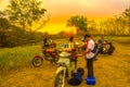 August 08, 2023. Surabaya, Indonesia. Barista on bike selling drinks during sunset in a hill forest.