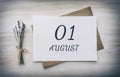 August 01. 01th day of the month, calendar date.White blank of paper with a brown envelope, dry bouquet of lavender flowers on a