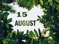 August 15, 15th day of month. Composition of natural green leaves with paper card. Summer month. Concept of Day of Year