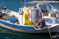 August 24th 2017 - Lipsi island, Greece - An old fisherman is working on his nets in Lipsi island, Dodecanese, Greece Royalty Free Stock Photo