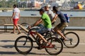 August 7, 2016: Three cyclists ride along the promenade