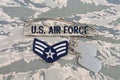 August 31, 2020. US AIR FORCE branch tape and Senior Airman rank patch and dog tags on digital tiger-stripe pattern Airman Battle