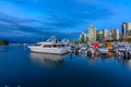 Sunset at Coal Harbour in Vancouver British Columbia with downtown buildings boats and reflections in the water Royalty Free Stock Photo