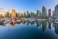 Sunset at Coal Harbour in Vancouver British Columbia with downtown buildings boats and reflections in the water Royalty Free Stock Photo