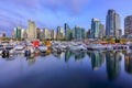 Sunset at Coal Harbour in Vancouver British Columbia with downtown buildings boats and reflections in the water Royalty Free Stock Photo