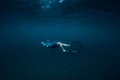 August 07, 2021. Varna, Bulgaria. Men glides with fins on deep in sea. Freediving underwater in transparent sea
