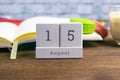 August 15 on the wooden calendar.The fifteenth day of the summer month, a calendar for the workplace. Summer