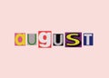 August word from cut out magazine colored letters on a light background